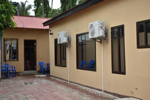 a building with two air conditioners on the side of it at Lunguya Lodge in Dar es Salaam