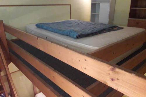 a bed sitting on top of a wooden bed frame at Appartement Barèges in Barèges