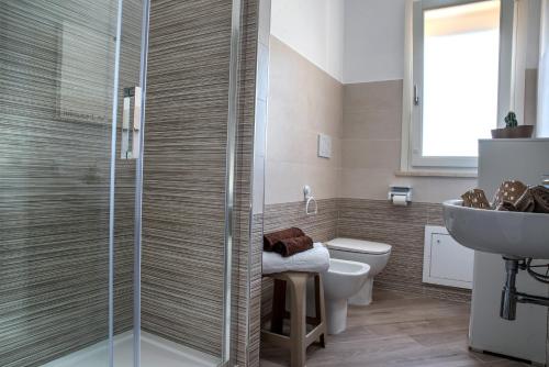a bathroom with a shower and a toilet and a sink at Marco's House in Alghero