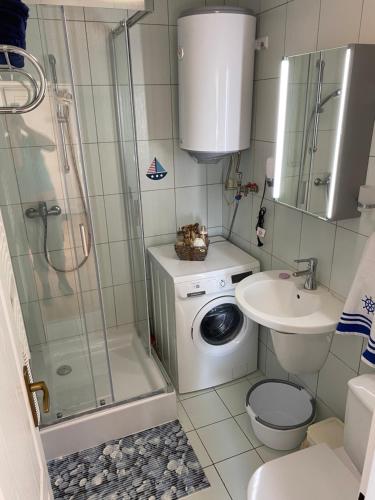 a bathroom with a shower and a toilet and a sink at Apartman Delfin in Senec
