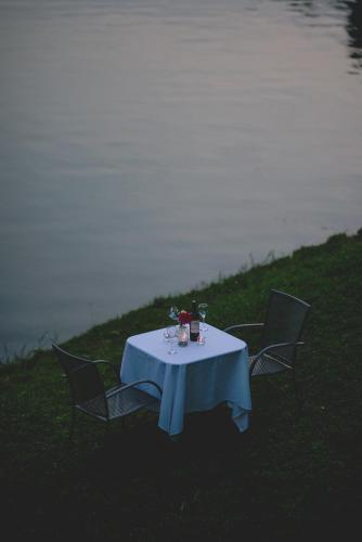 a table with a blue table cloth and two chairs at Inn on the lake in Kibuye