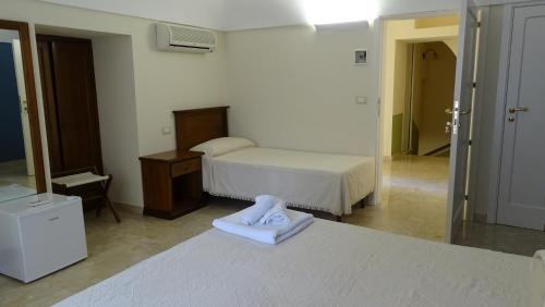 ein Hotelzimmer mit einem Bett und einem Spiegel in der Unterkunft CATANIA - Historic B&B Apartments Home in Chiaramonte Gulfi
