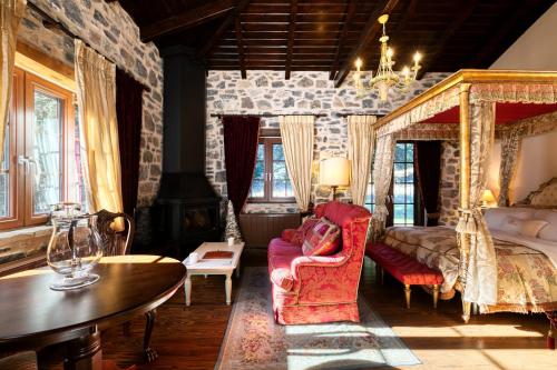 a bedroom with a bed and a couch and a table at All Seasons Paradise in Khrisovítsion