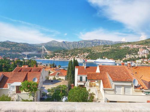 a view of the city of dubrovnik with a cruise ship at Adria Apartments and Rooms in Dubrovnik