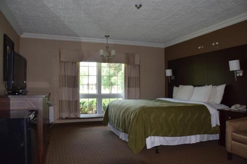 a hotel room with a bed and a window at Rodeway Inn Festival in Stratford
