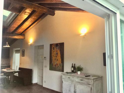 a room with a white wall with a painting on the wall at Casetta di Chri in Chiavari