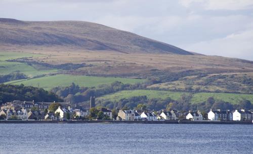 a group of houses on the shore of a body of water at The Glenburn Hotel in Rothesay