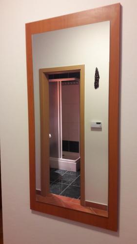 a mirror on a wall in a bathroom at Apartmán Tatran A 12 in Donovaly