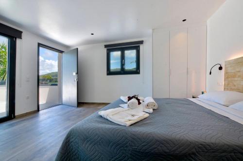 a bedroom with a large bed with towels on it at Villa Flamingo - 4 bedrooms - Private Pool - Next to renowned Issos Beach & Lake Korission in Línia