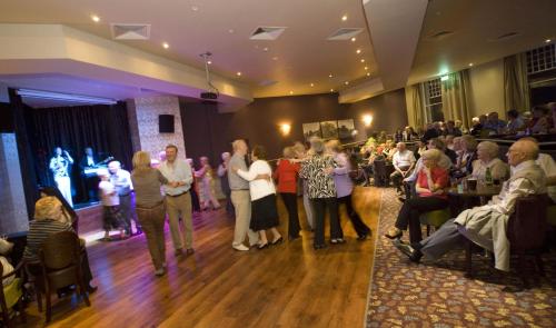 a group of people standing on a dance floor at The Glenburn Hotel in Rothesay