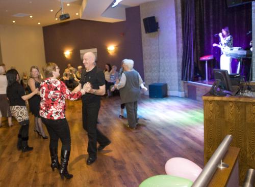 a group of people dancing on a dance floor at The Glenburn Hotel in Rothesay