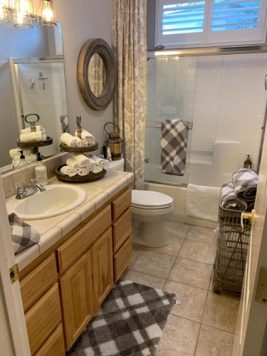 a bathroom with a sink and a toilet and a shower at Yahweh House in Redding