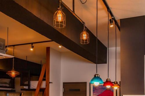a group of pendant lights hanging from a ceiling at Good Day Hotel in Chatan