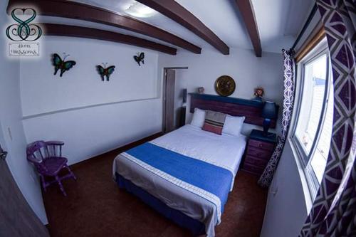 a bedroom with a large bed in a room at Hotel Tres Sofias in Querétaro