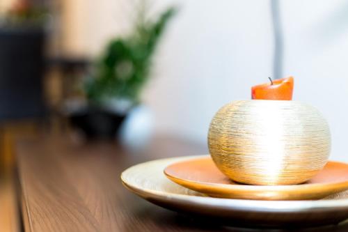 a candle sitting on a plate on a table at Arpad Bridge Apartments in Budapest
