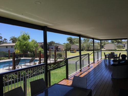 a balcony with a view of a swimming pool at Laguna lodge Group Accommodation in Sussex inlet
