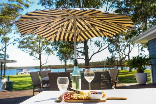 an umbrella sitting on top of a table at Laguna lodge Group Accommodation in Sussex inlet