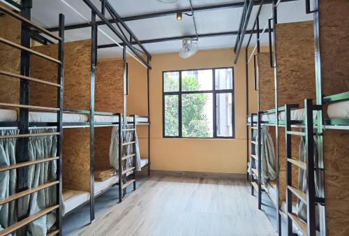 a room with four bunk beds and a window at Leo Backpackers @ Central Market in Kuala Lumpur