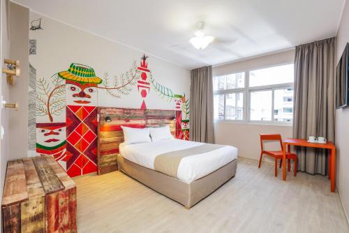 a hotel room with a bed and a table at Gondwana City Art in Noumea