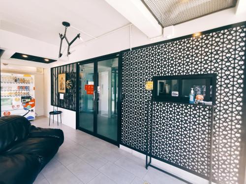 a room with a black and white patterned wall at Star Sukhumvit in Bangkok