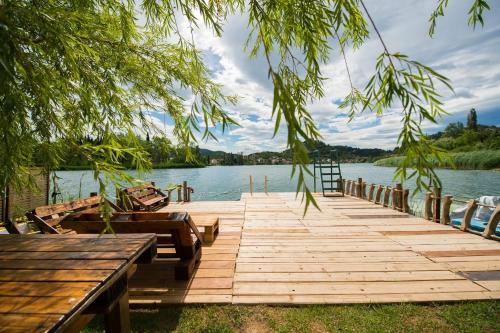 a wooden dock with a boat on the water at Apartmani Galić in Ploče