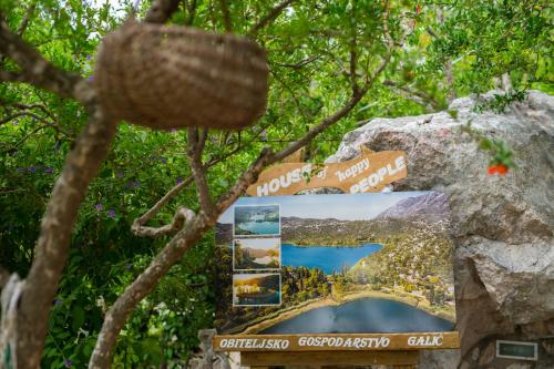 a sign on a rock with a picture of a lake at Apartmani Galić in Ploče
