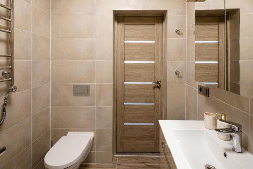 a bathroom with a toilet and a sink at Art Design King Bed Studio Apartment In Old Town in Rīga