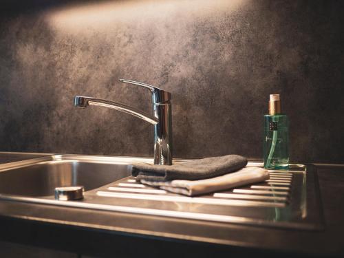 a sink with a towel and a bottle of soap at Haus Veronika - Appartements by Miha in Westendorf