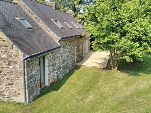 an aerial view of a stone house with a yard at Le Botcol in Plouguernével