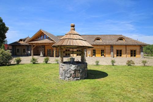 a large house with a gazebo in the yard at Ułańska Zagroda in Człopa