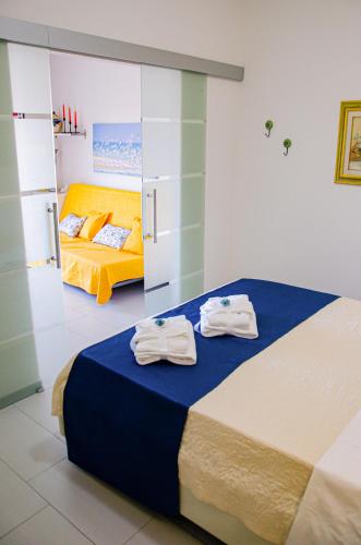 a bedroom with two beds with towels on them at La casa di pasqui in SantʼAntonio Abate