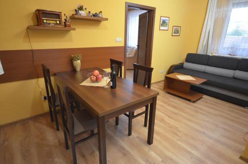 a living room with a table and a couch at Apartmány Best I. Bešeňová in Bešeňová