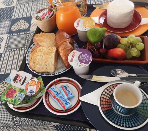 a table with a tray of breakfast foods and coffee at B&B La Terrazza in Alghero