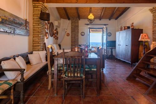 a living room with a couch and a table at Eros Pittoresque Retreats - Perfect location, Panoramic Seaview in Koroni