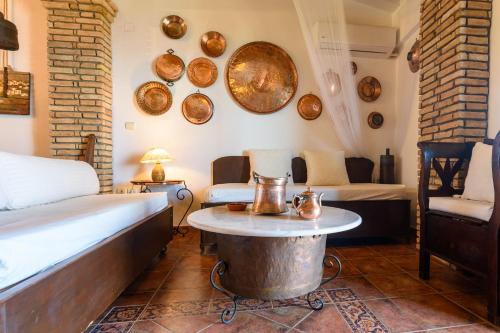 a room with a bed and a table with plates on the wall at Eros Pittoresque Retreats - Perfect location, Panoramic Seaview in Koroni
