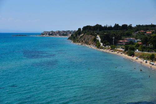 an aerial view of a beach with people in the water at Oceanview 1 in Nea Kalikratia