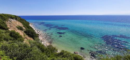 an aerial view of a beach with blue water at Oceanview 1 in Nea Kalikratia