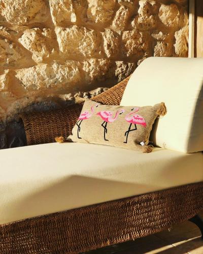 a pillow on a bed with a stone wall at Kamares Stone House 2 in Gerolimenas