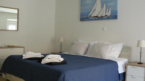 a bedroom with a bed with two towels on it at Eco Apartments Kate in Suđurađ