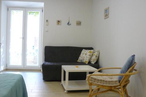 a living room with a couch and a table at Eco Apartments Kate in Suđurađ