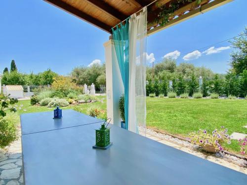 a patio with a table and a view of a yard at Villa Doma with private pool for up to 29 guests by DadoVillas in Roda