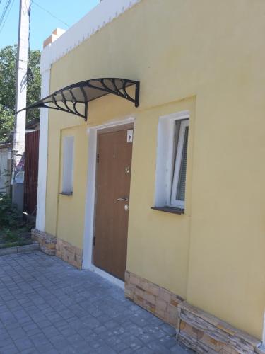 a building with a brown door on the side of it at Смарт квартира in Odesa
