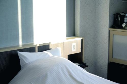 a bedroom with a bed and a television at Mizno Hotel in Fujikawaguchiko