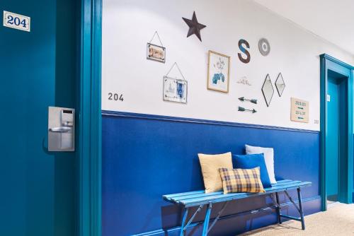 a blue wall in a room with a blue bench at Hôtel Stanley by HappyCulture in Nancy