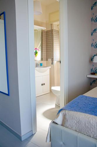 a bedroom with a bed and a bathroom at La casa di paola in SantʼAntonio Abate