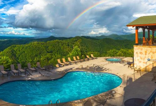 a rainbow over a pool at a resort with a beach at Extravagant View Cabin in Park Settlement