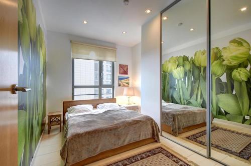 a bedroom with two beds and a mirror at Helios Luxury apartment in Vilnius skyscraper in Vilnius