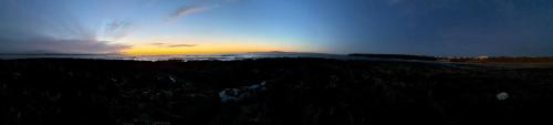 a sunset on top of a mountain with the ocean at McMunns of Ballybunion in Ballybunion