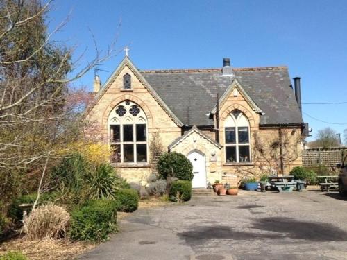 a large brick house with a white door at Chalk and Cheese in Shouldham Thorpe