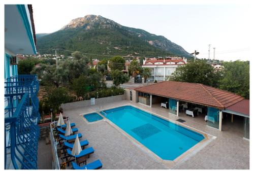a view of a swimming pool with a mountain in the background at Mavi Yaprak Hotel in Oludeniz
